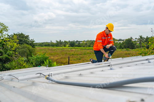Preview: technician lifting a photovoltaic panel during installation