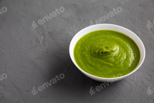 Preview: Homemade Organic Broccoli Soup on gray surface, side view. Copy space.