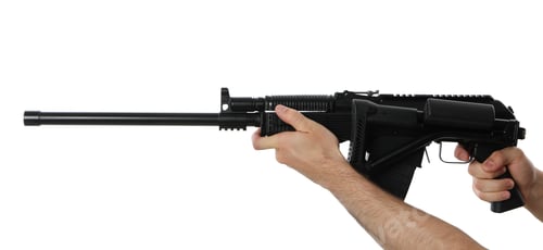 Preview: Male hands hold automatic gun with folding butt, isolated on white background