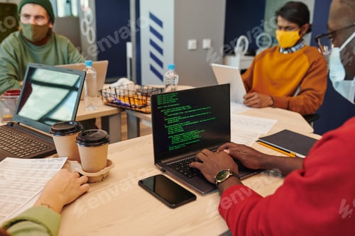 Preview: Smiling young businesswoman on laptop display talking to male colleague