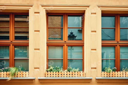 Preview: Vintage building facade with windows and flowers on windowsill
