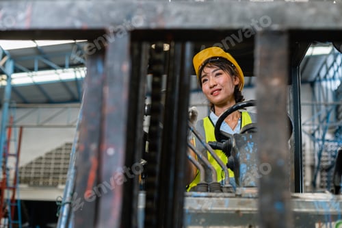 Preview: women wear safety helmet happy smiling looking at camera driver forklift.
