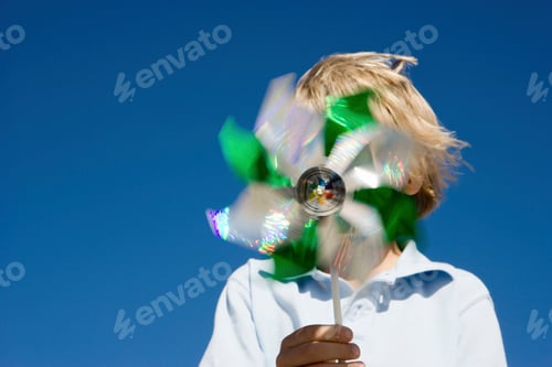 Preview: Boy holding pinwheel in front of face