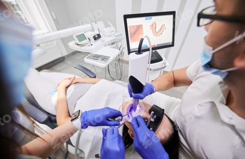 Preview: Doctor scanning patient mouth with modern intraoral scanner.