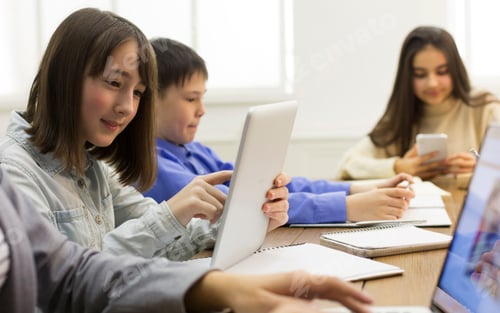 Preview: E-learning in school. Girl doing homework, using digital tablet