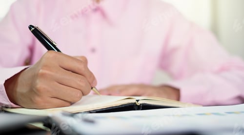 Preview: The businessman hand sits at their desks and calculates financial graphs showing the results