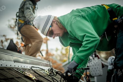 Preview: Construction crew installing solar panels on a house