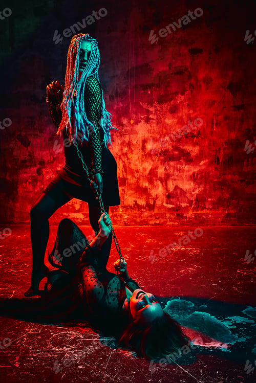 Preview: Women in halloween outfit posing with on a blue background. Gorgeous girl in clothes celebrates the