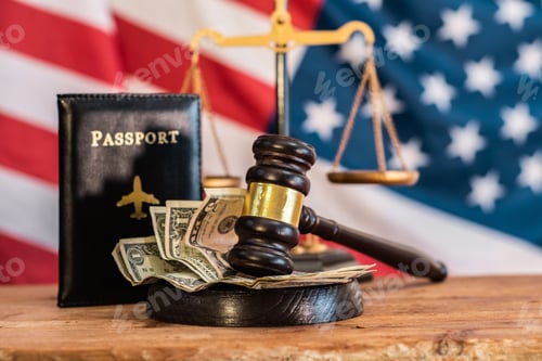 Preview: A judge's gavel, money, a passport placed together against of the American flag