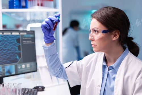 Preview: Biotechnologist doctor analysing a blood tube for medical investigation