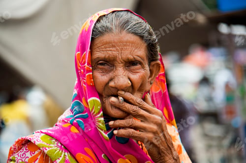 Preview: Old age woman smoking Indian handmade cigarette.