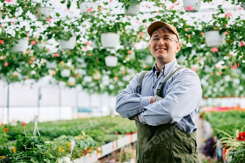 Preview: Portrait of confident plant nursery owner looking at camera.