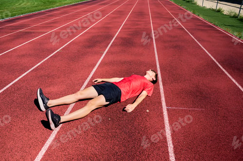 Preview: A man is laying on the track, exhausted from running