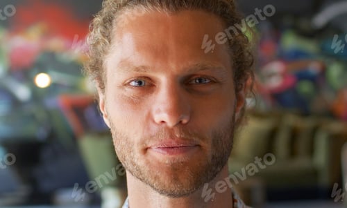 Preview: Portrait Of Young Man In Urban Setting With Graffiti Covered Wall Behind