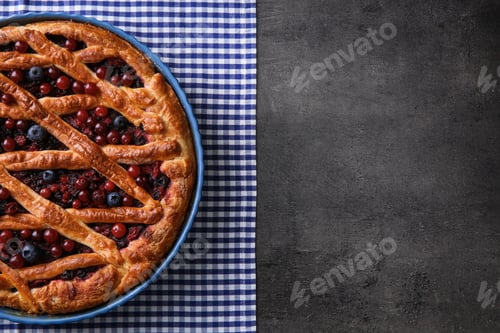 Preview: Delicious currant pie and fresh berries on grey table, top view. Space for text