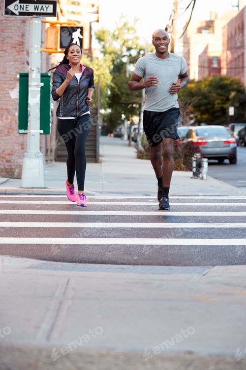 Preview: Young black couple jogging in Brooklyn, vertical