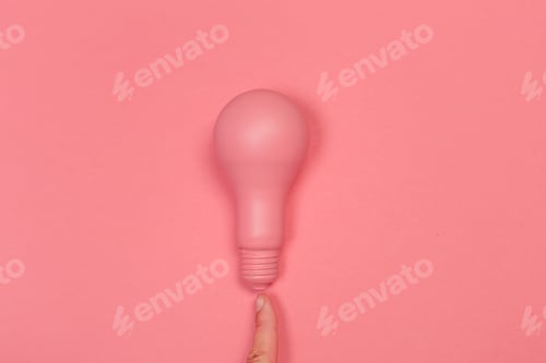Preview: Pink light bulb contrasts with pink background in creative minimalistic setting
