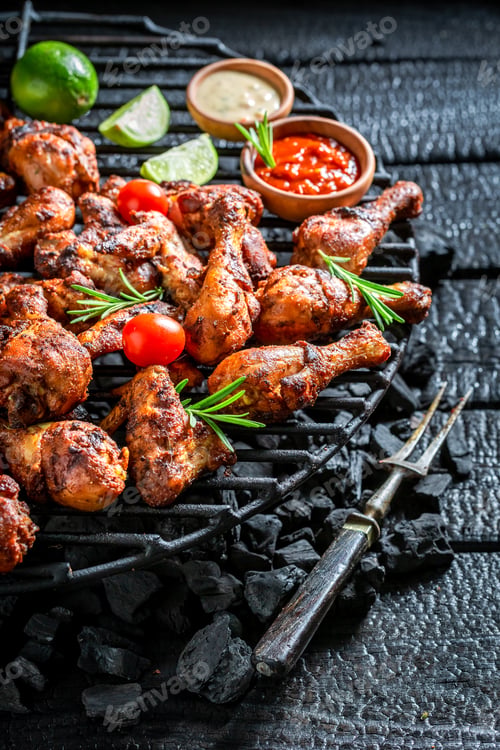 Preview: Tasty grilled chicken leg with sauces and lime