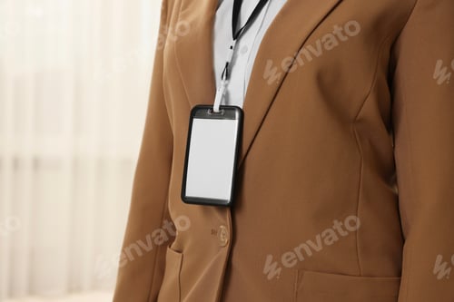Preview: Woman with blank badge indoors, closeup. Space for text