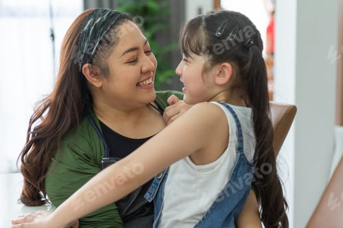 Preview: Mother hug and talk with little daughter at home.