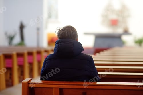 Preview: Religious middle age man praying and meditating in catholic church. Person begging for forgiveness
