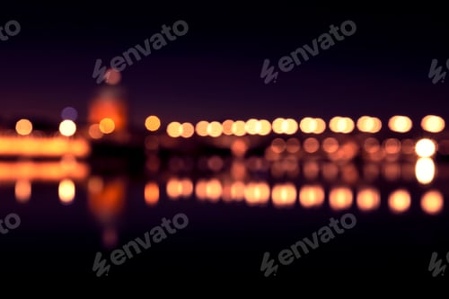Preview: Background with blurred lights of lanterns at night. reflection of bokeh in river. Toulouse, France