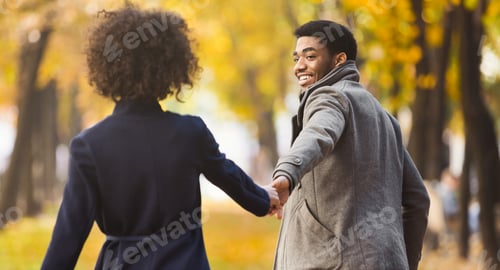 Preview: Follow me. Happy couple walking in autumn city park
