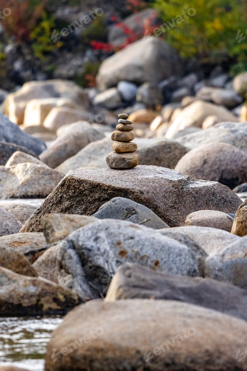 Preview: there is a stack of rocks stacked on each other at the river bank