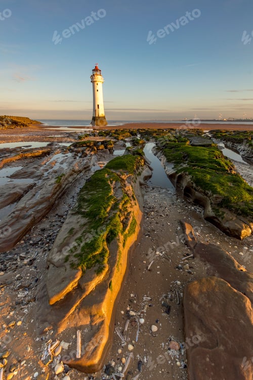 Preview: Stunning twilight scene featuring a rocky beach and an iconic New Brighton Lighthouse