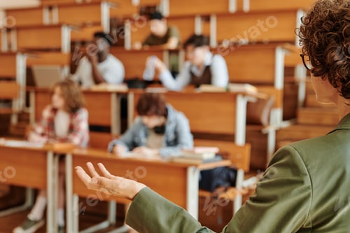 Preview: Young confident college teacher or lecturer explaining one of lesson points
