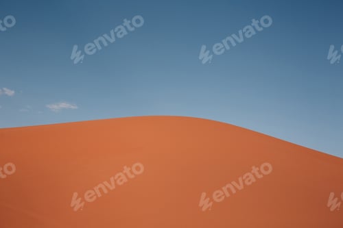 Preview: Sand dune in the desert with blue sky.