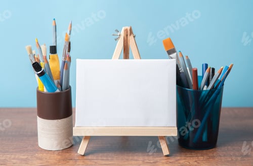 Preview: small wooden easel with blank canvas on wooden table