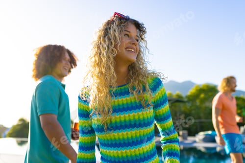 Preview: Happy caucasian woman dancing with her friends at party in garden