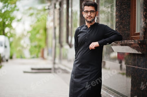 Preview: Pakistano bangladesh man wear black traditional clothes and eyeglasses pose outdoor.