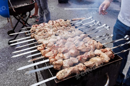 Preview: Traditional Turkish kebab on hot burning grill with skewers