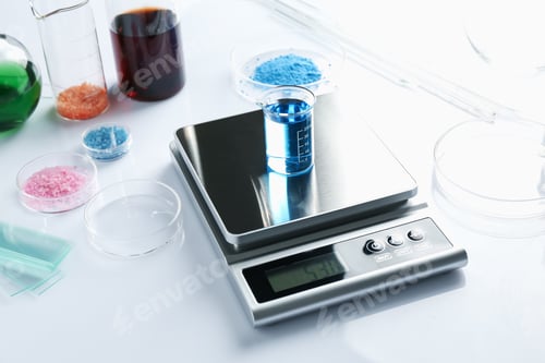 Preview: Scale with beaker of sample and other laboratory equipment on white background