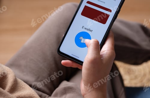 Preview: close up woman choose payment online on shopping mobile app on sofa at home