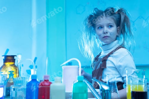 Preview: Cute little girl during chemistry lesson in school
