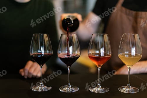 Preview: sommelier pouring wine into wine glasses for wine tasting