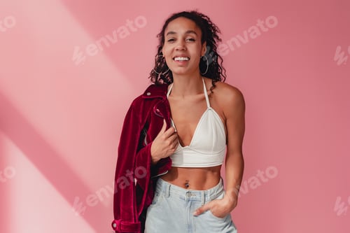 Preview: attractive black african american woman in stylish outfit on pink background