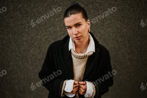Preview: Portrait of a fashionable woman with piercings standing on street.