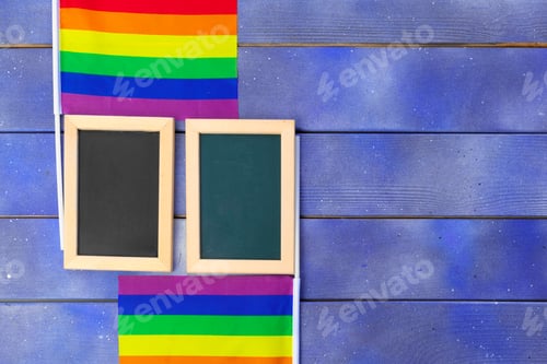 Preview: Bright rainbow gay flag on wooden background and blank space