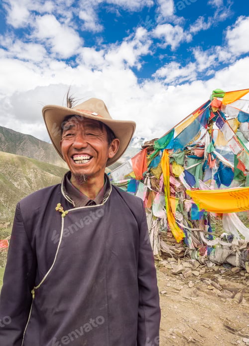 Preview: Smiling Man in Nature Beside Prayer Flags