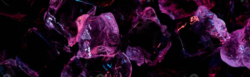 Preview: Panoramic Shot of Transparent Ice Cubes With Purple Lighting Isolated on Black