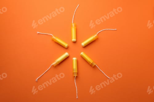 Preview: Women tampons on orange background, top view