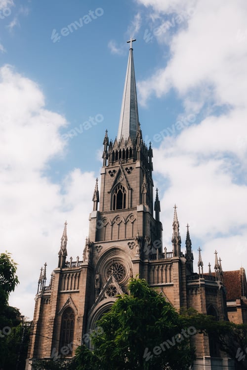 Preview: Gothic cathedral with ornate spire against a blue sky.