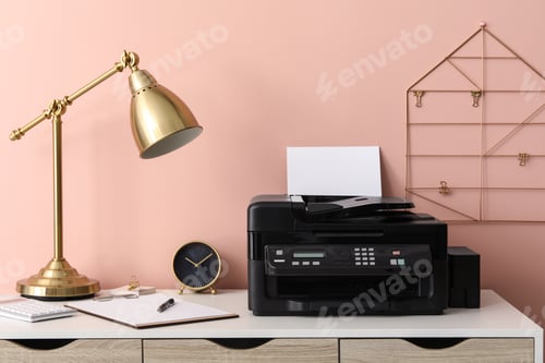 Preview: New modern printer with paper on white table at workplace