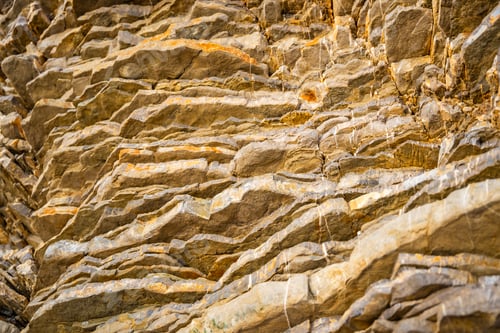 Preview: Layered rock texture in Budva, Montenegro. Sedimentary rocks with rugged surface of gray and brown