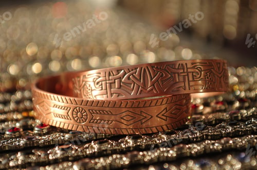 Preview: Closeup shot of copper bracelets with patterns
