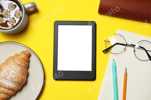 Preview: Flat lay composition with modern e-book reader on yellow background